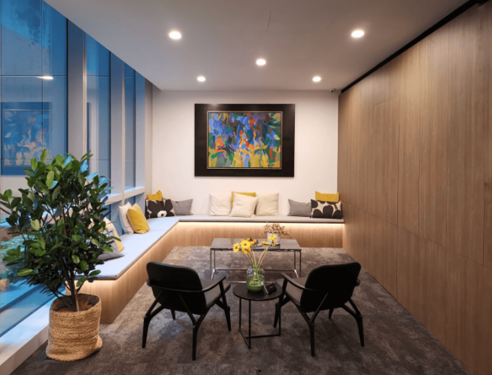 Inside the NOVI Health clinic — a bright, wood-panelled lounge with soft seating, a large plant and natural light.